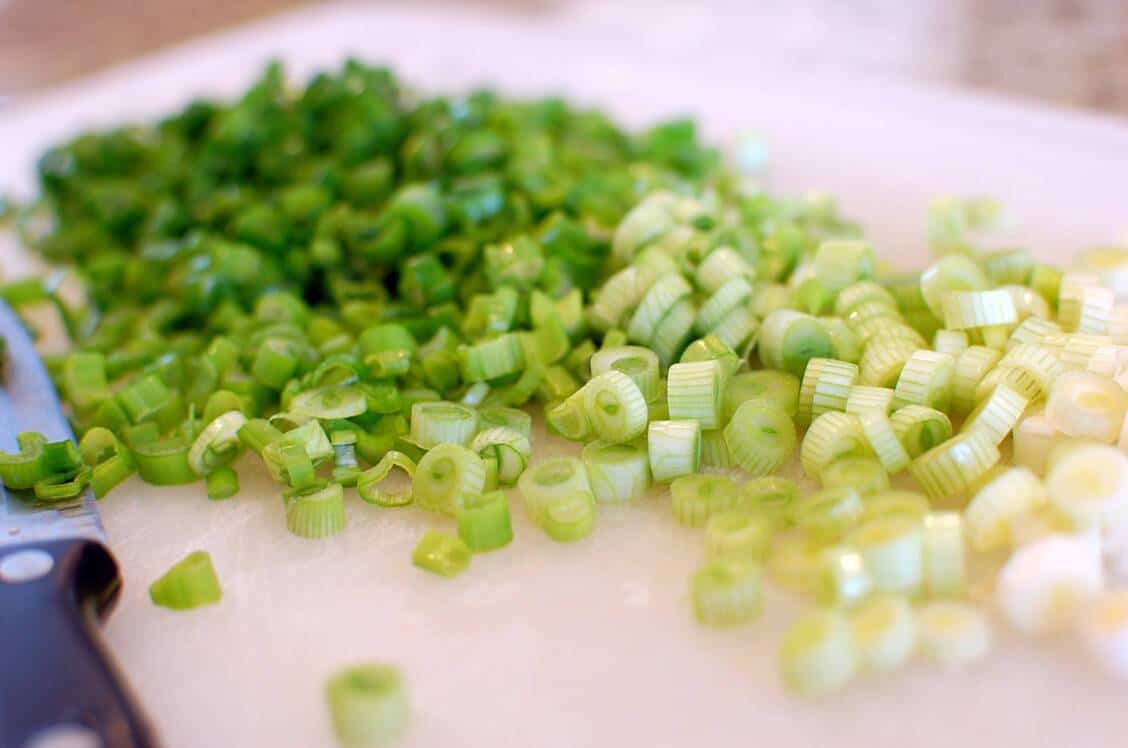 chopped green onions on top of extra thick and chewy noodles